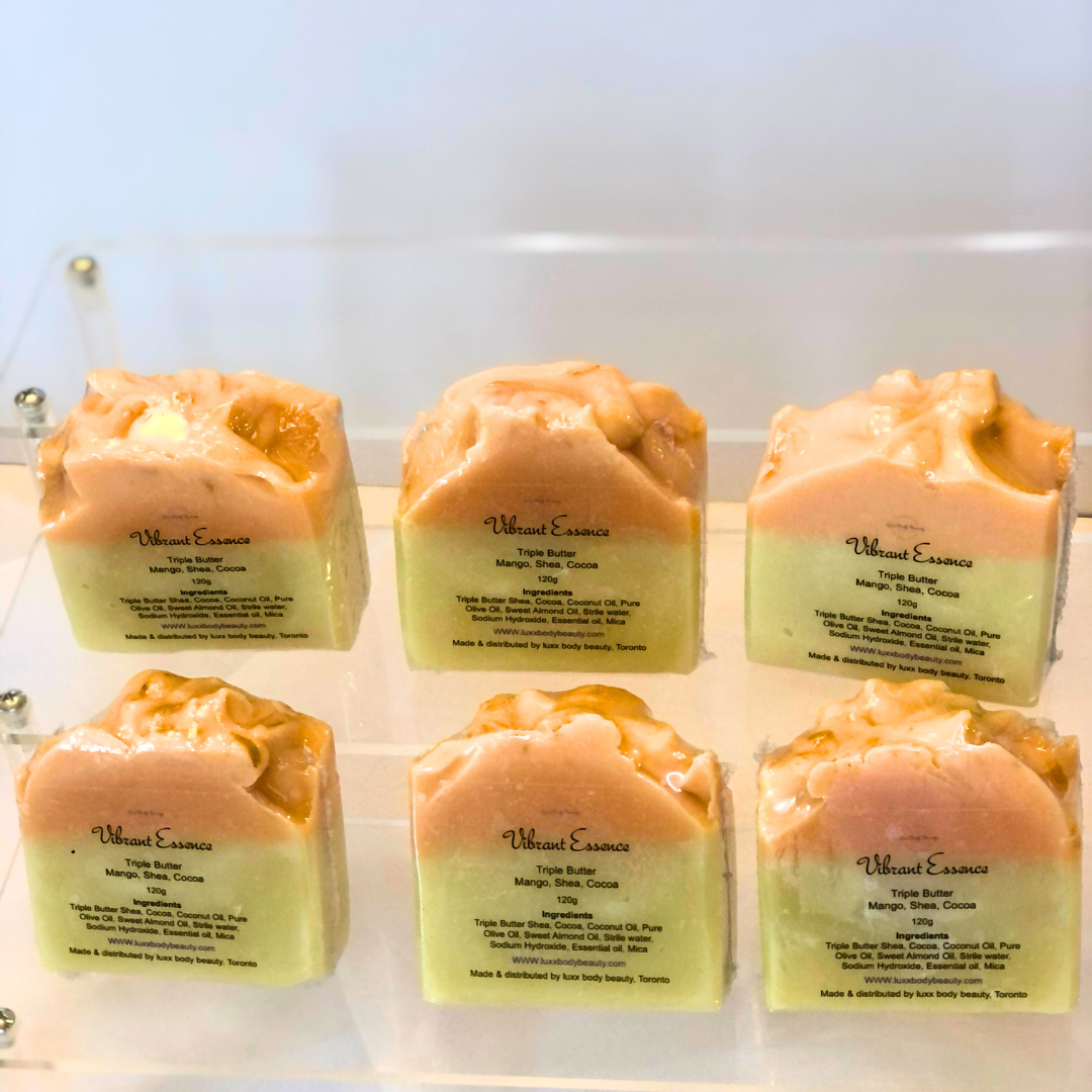 A soap bar with a yellow bottom layer, an orange top layer, and a touch of golden color decoration.
