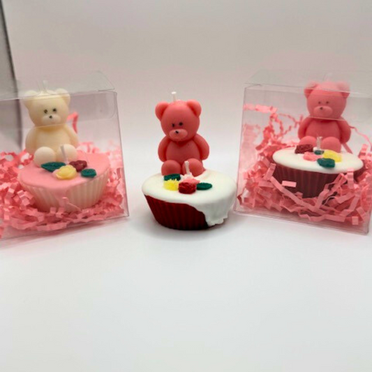Cupcake candles with a teddy bear and flowers on the top. The candles come in different colors pink, white, and red in a clear box as a gift.