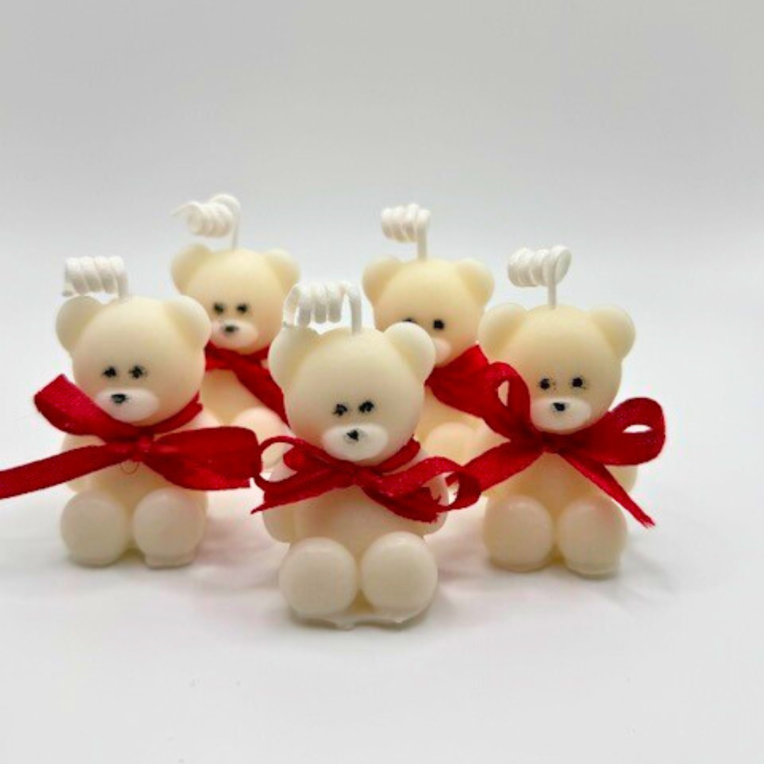 A white teddy bear candles with red bow ribbon around the neck. A perfect gift for Valentine's Day