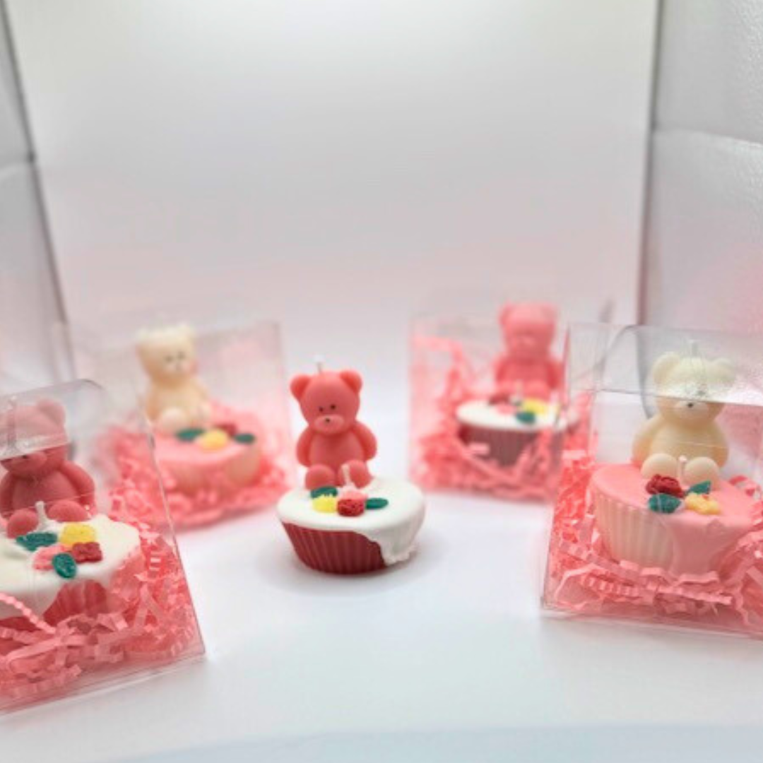Cupcake candles with a teddy bear and flowers on the top. The candles come in different colors pink, white, and red in a clear box as a gift.