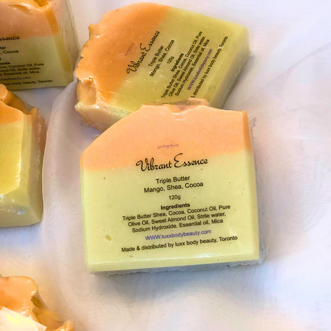 A soap bar with a yellow bottom layer, an orange top layer, and a touch of golden color decoration.