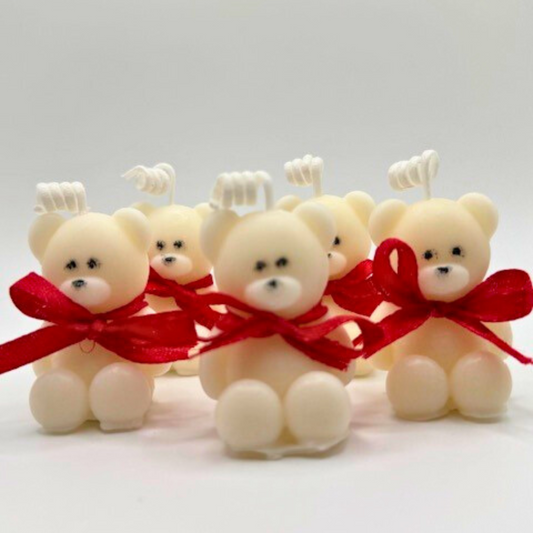 A white teddy bear candles with red bow ribbon around the neck. A perfect gift for Valentine's Day