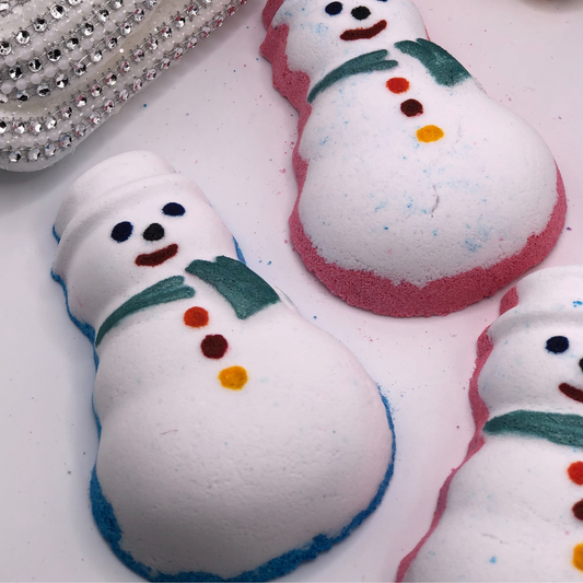 A snowman-shaped bath bomb decorated with colorful details.