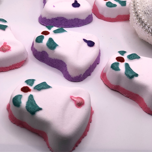 A Christmas Bell-shaped bath bomb decorated with colorful details.