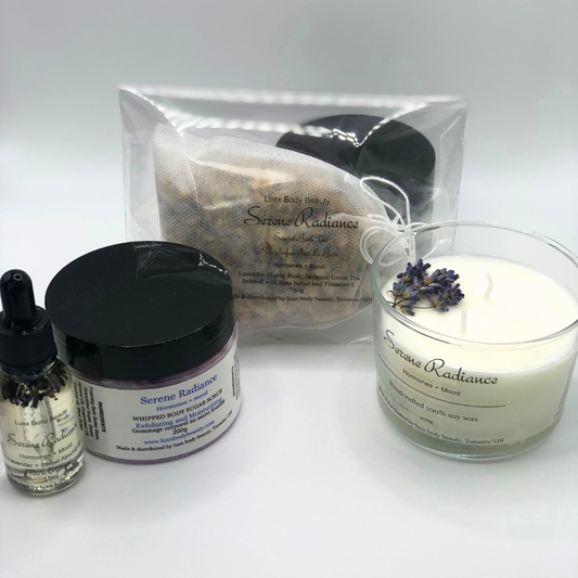 A home spa day set featuring a candle, body oil bottle, bath tea, and sugar scrub jar.