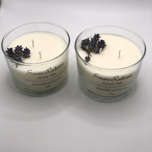 A single-wick white candle in a clear jar, topped with a dried Lavender floral decoration.