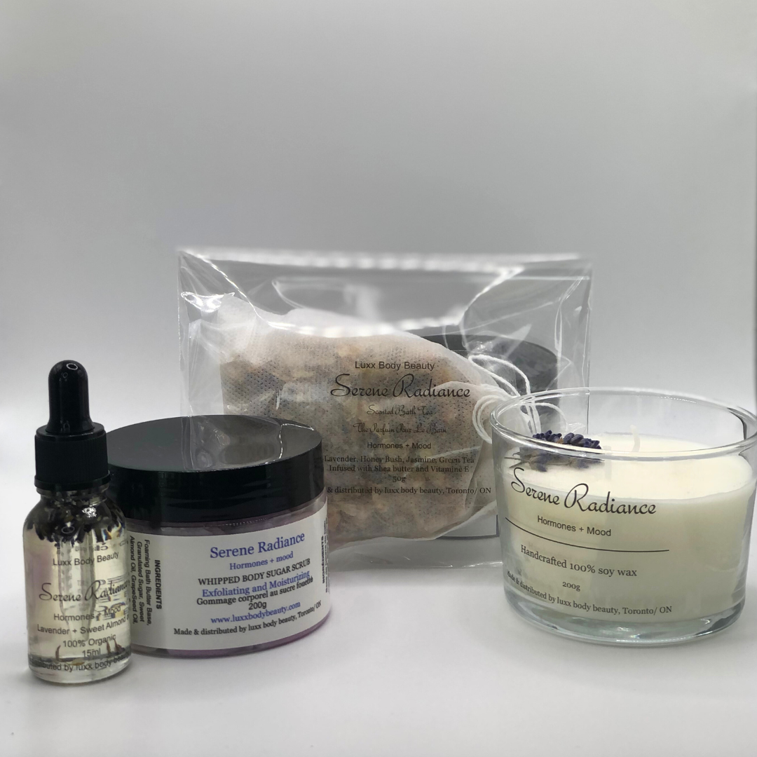 A home spa day set featuring a candle, body oil bottle, bath tea, and sugar scrub jar.