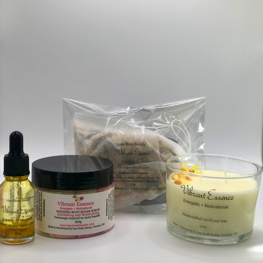 A home spa day set featuring a candle, body oil bottle, bath tea, and sugar scrub jar.