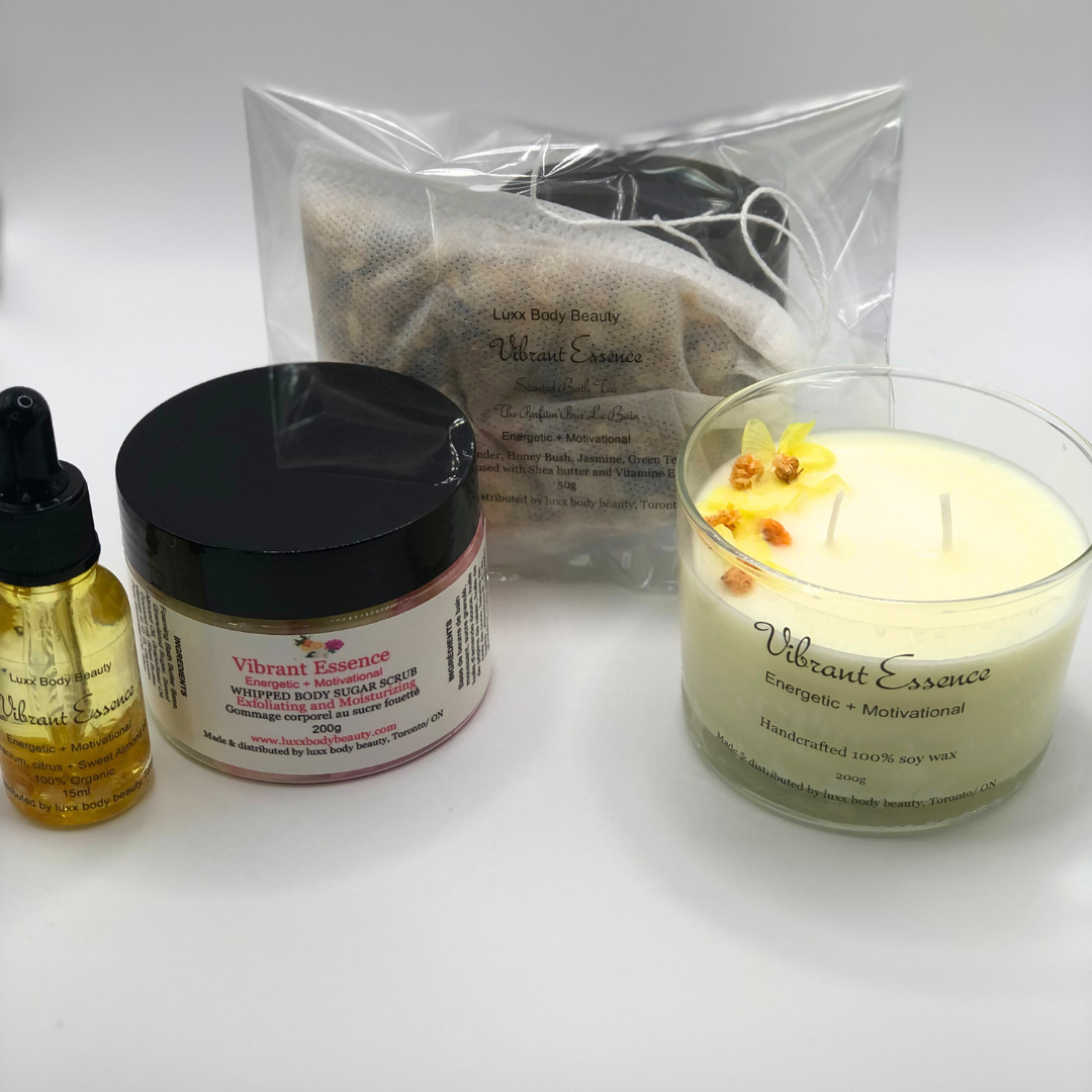 A home spa day set featuring a candle, body oil bottle, bath tea, and sugar scrub jar.