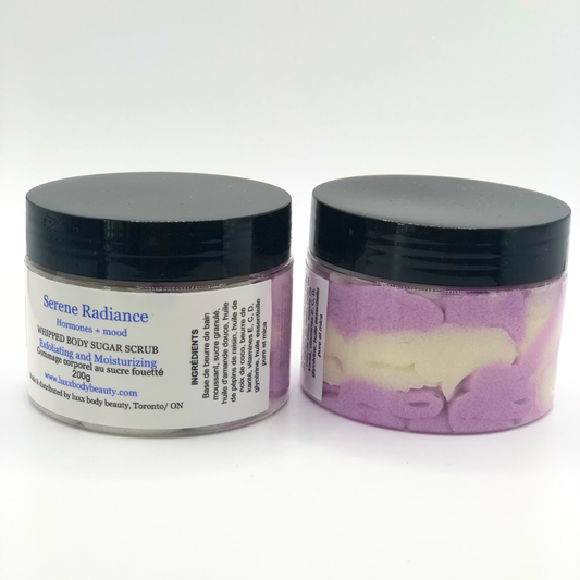 A whipped foamy sugar scrub in a clear jar is made of white and purple layers