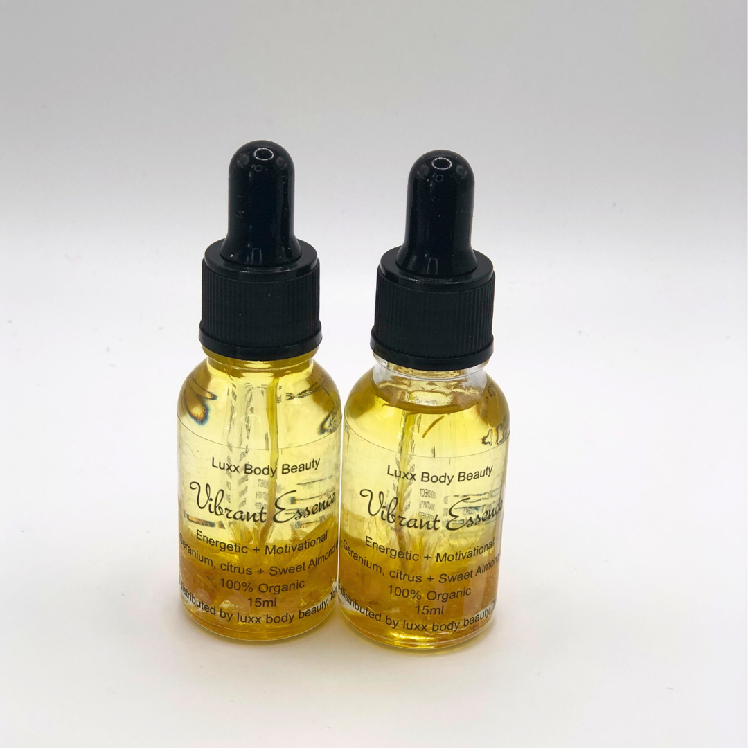 A small clear bottle with a dropper, containing body oil infused with witch hazel flower.