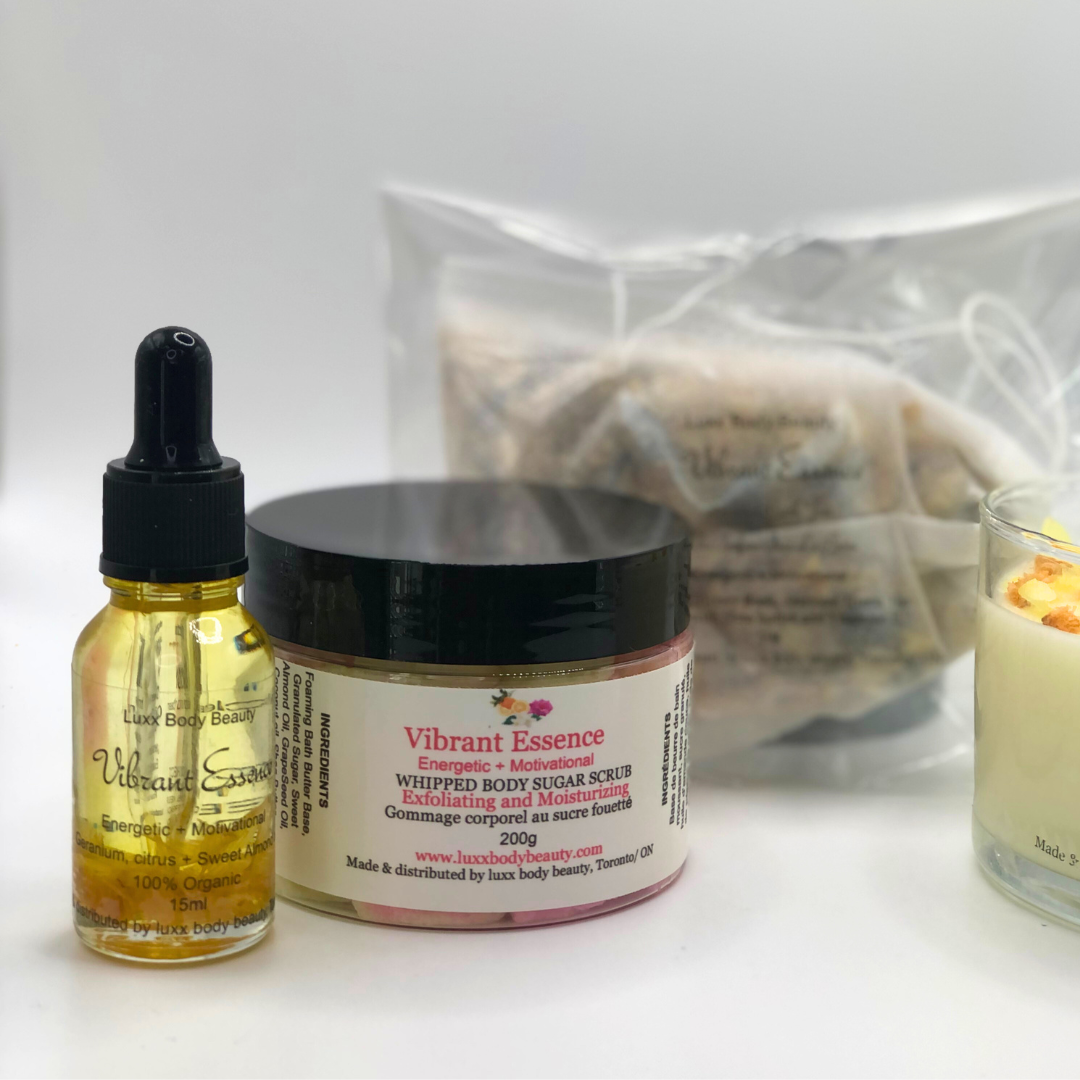 A home spa day set featuring a candle, body oil bottle, bath tea, and sugar scrub jar.