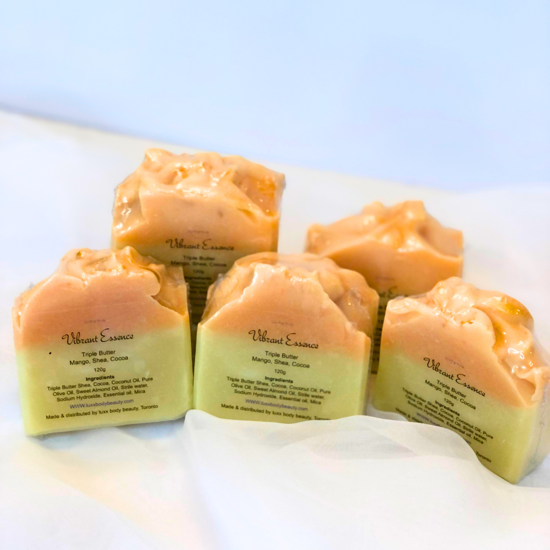 A soap bar with a yellow bottom layer, an orange top layer, and a touch of golden color decoration.