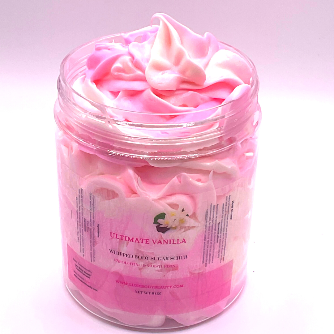 A whipped foamy sugar scrub of pink and white colors piped in a clear jar.