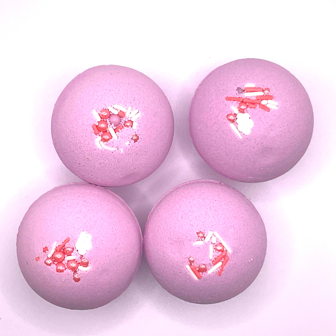 A purple round bath bomb topped with white and pink pearls.