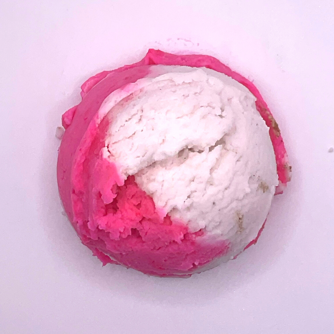 An ice cream scoop-shaped bubble bath in pink and white.