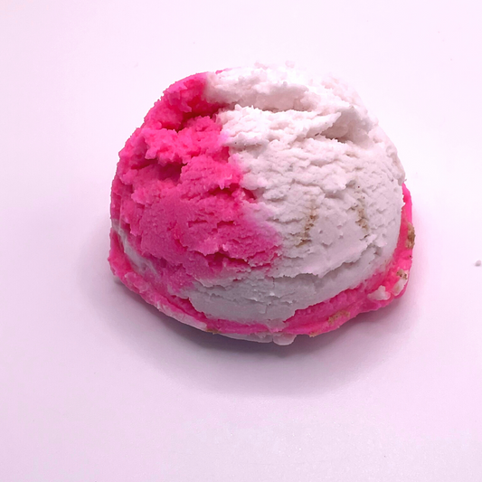 An ice cream scoop-shaped bubble bath in pink and white.