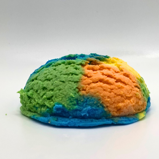 An ice cream scoop-shaped bubble bath in yellow, orange, green, and blue.