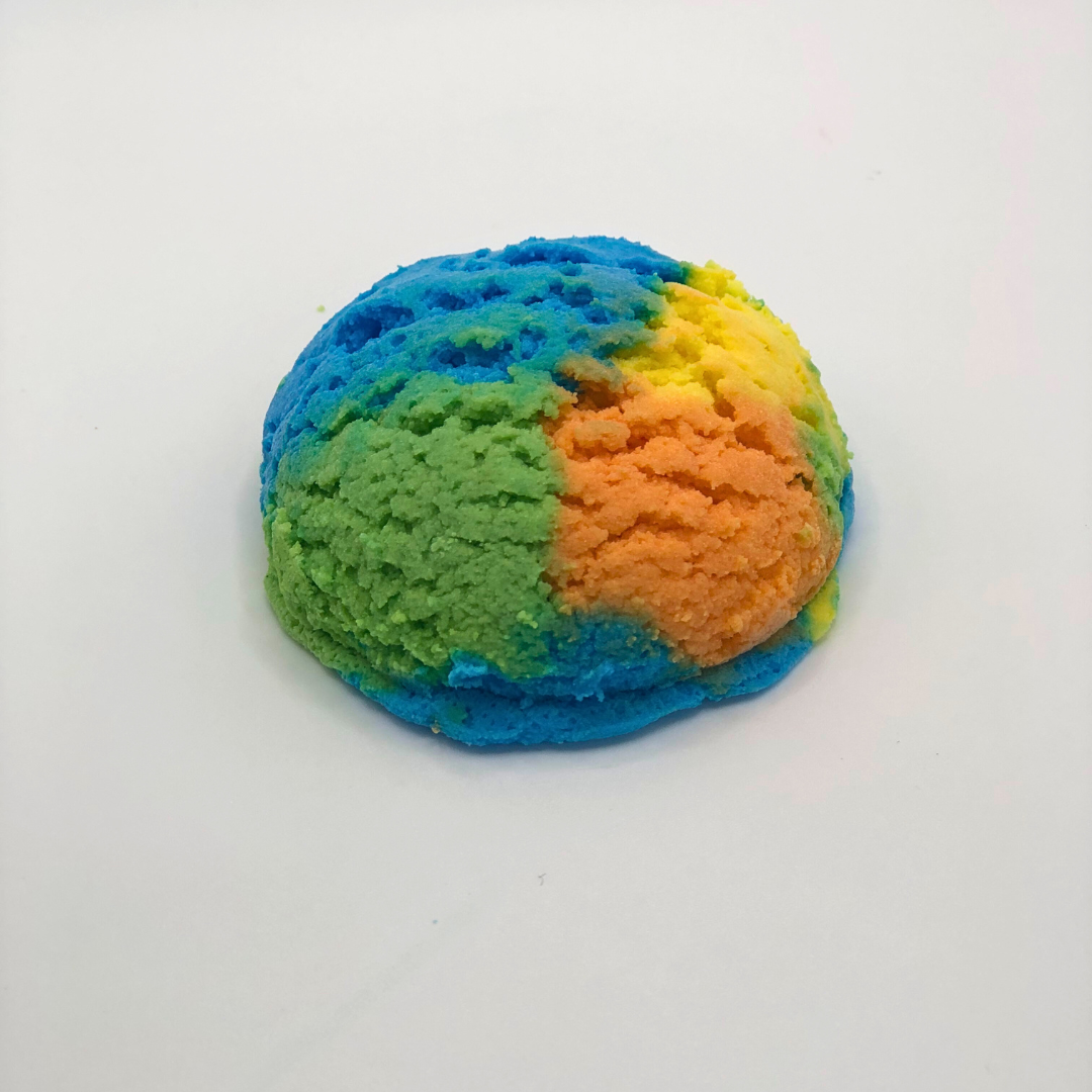 An ice cream scoop-shaped bubble bath in yellow, orange, green, and blue.