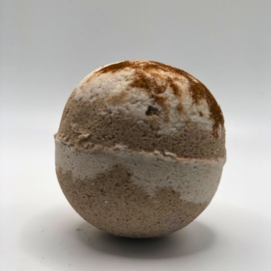 A round bath bomb with chocolate and off-white colors.