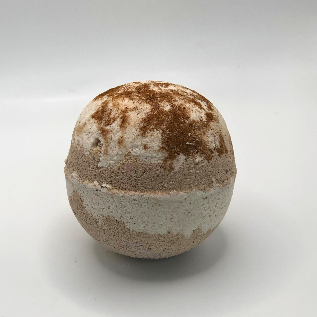 A round bath bomb with chocolate and off-white colors.
