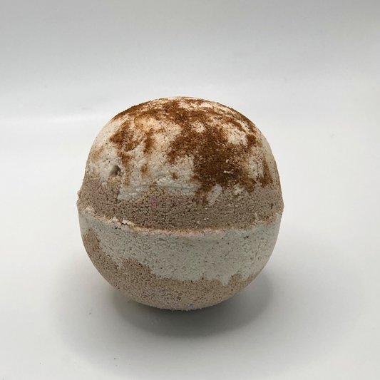 A round bath bomb with chocolate and off-white colors.