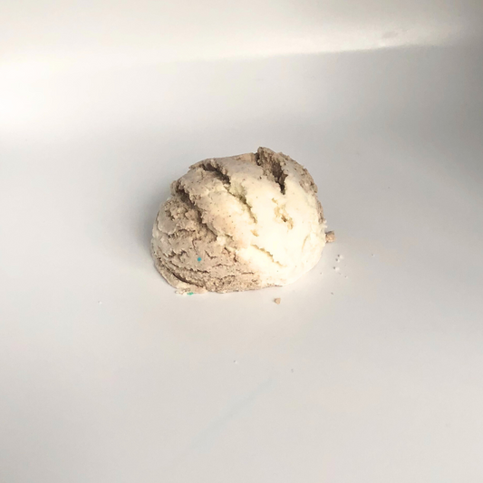 An ice cream scoop-shaped bubble bath in chocolate and off white.